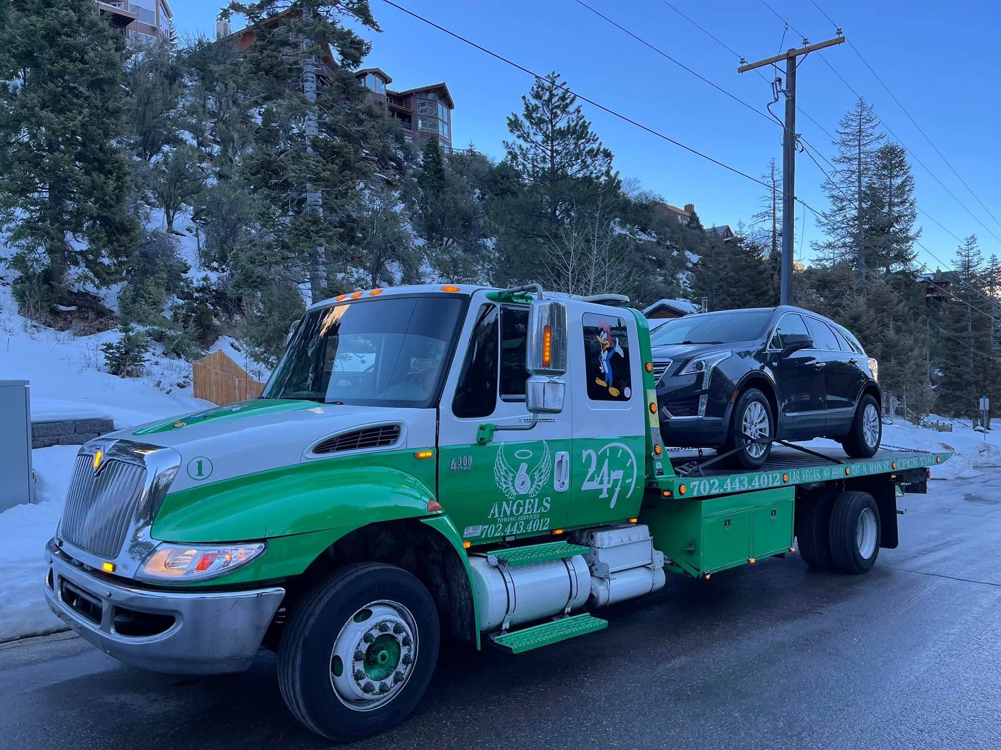 6 Angels tow truck operating in snowy mountain conditions